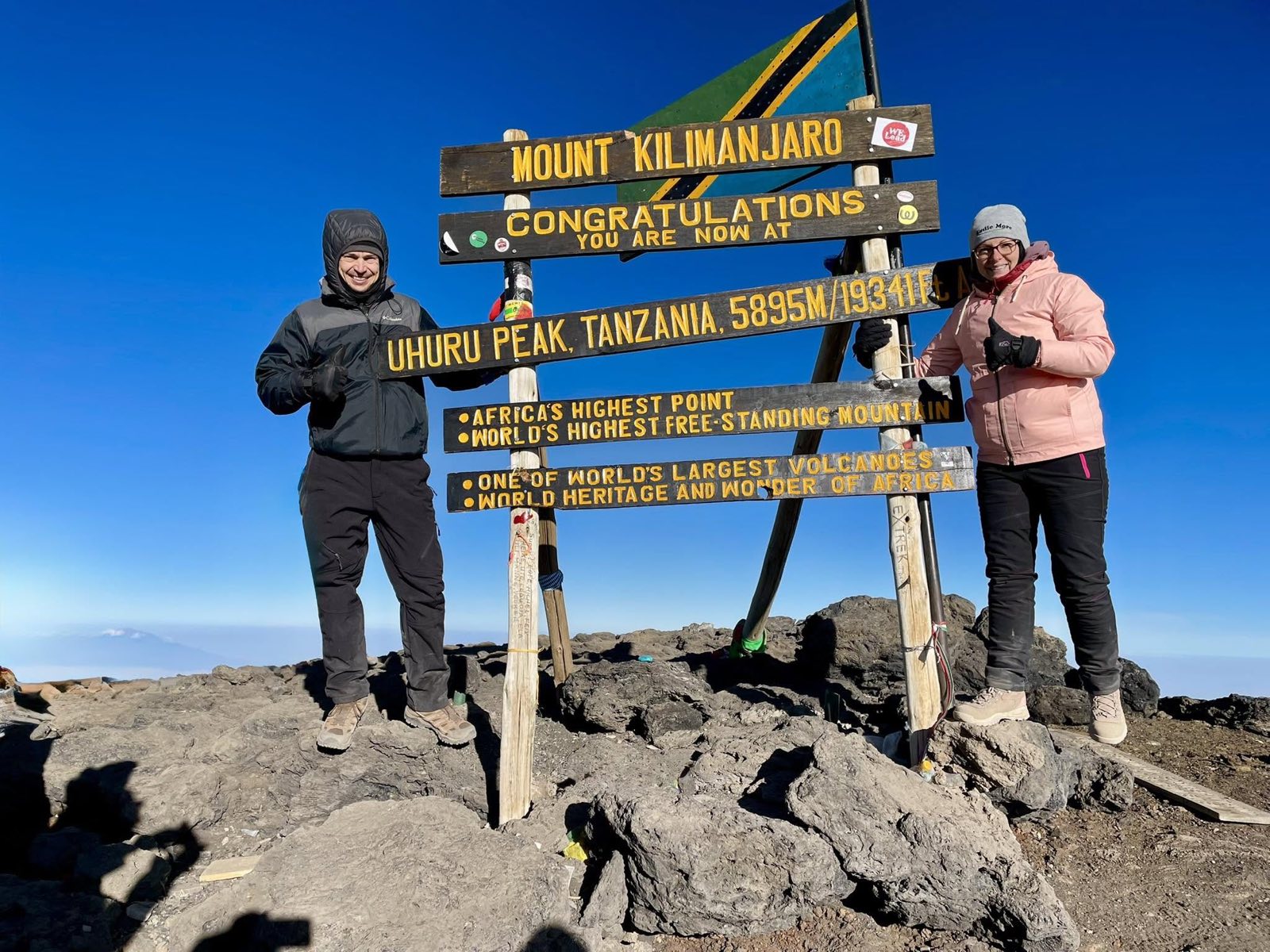 Marta and Miro at the Uhuru Peak summit sign, Mount Kilimanjaro